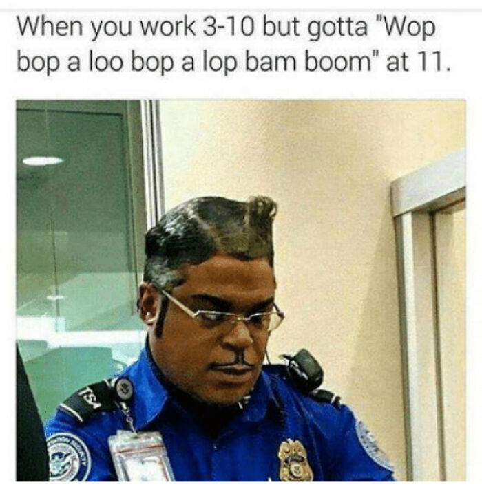 A man in a TSA uniform with a perfectly sculpted, unusual, and bad hair mistake.