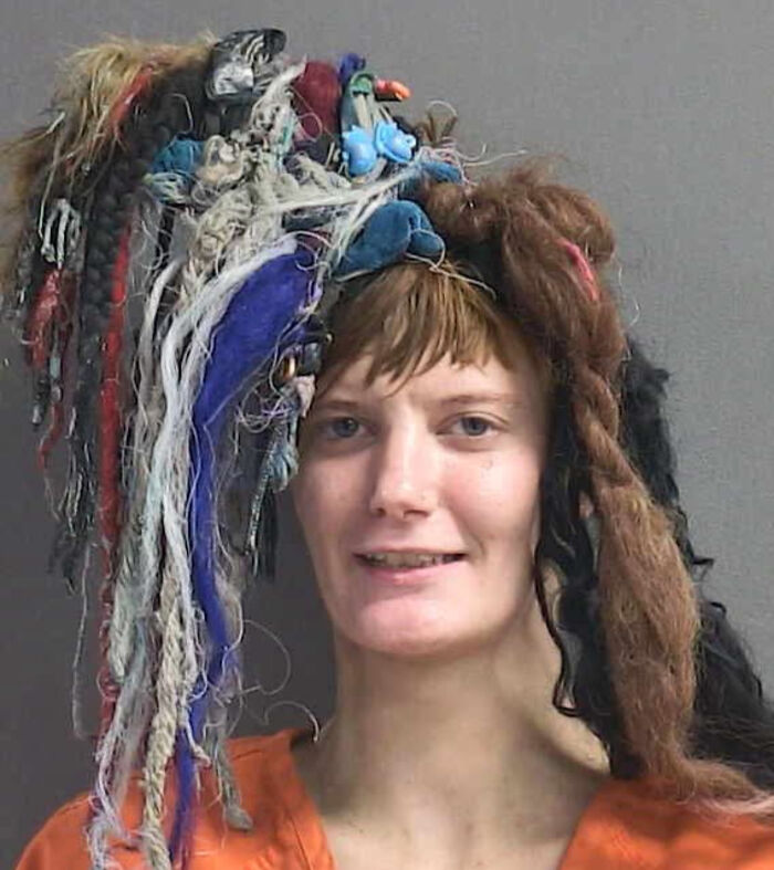 A woman with a wild, multi-colored and textured hairstyle, showcasing a bad hair mistake.