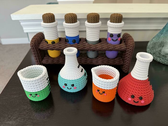 A set of colorful 3D printed laboratory beakers and test tubes with cute faces, showcasing cool projects.
