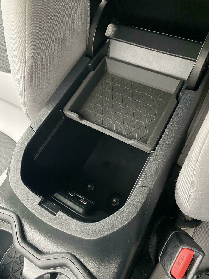 A custom 3D printed organizer tray inserted into a car's center console, showcasing a cool 3D print project.