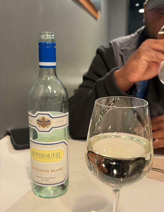 A bottle and glass of Rombauer Sauvignon Blanc wine, highlighting entitled men ignoring boundaries.