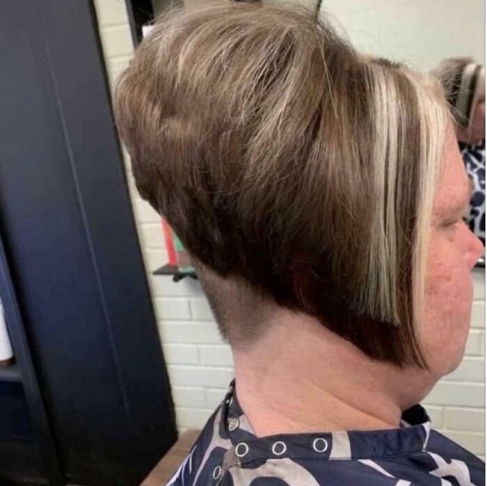 A woman with a dramatically layered bob haircut featuring blonde highlights and a very short nape. This highlights bad hair mistakes.