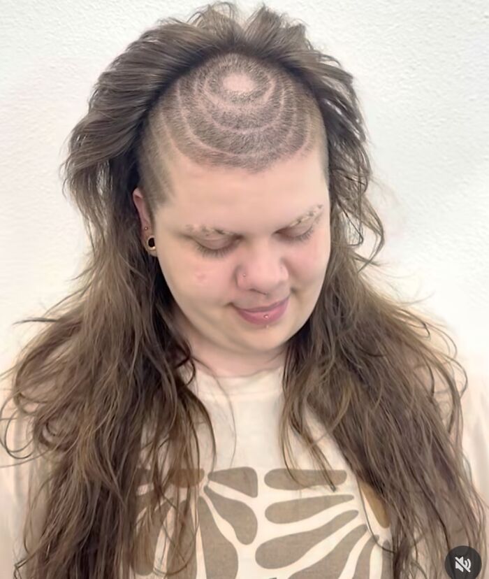 Person with long hair and a shaved head featuring circular patterns on the crown, a hilariously bad hair mistake.