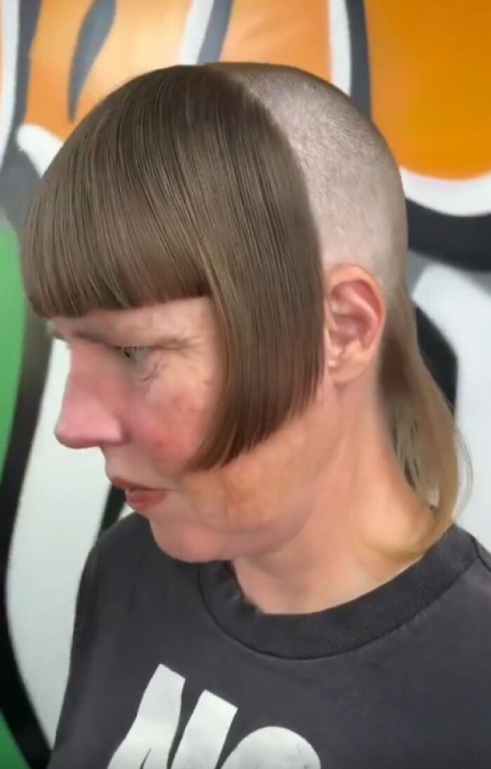A person with an unusual haircut featuring a blunt fringe, shaved sides, and a short mullet, a clear bad hair mistake.