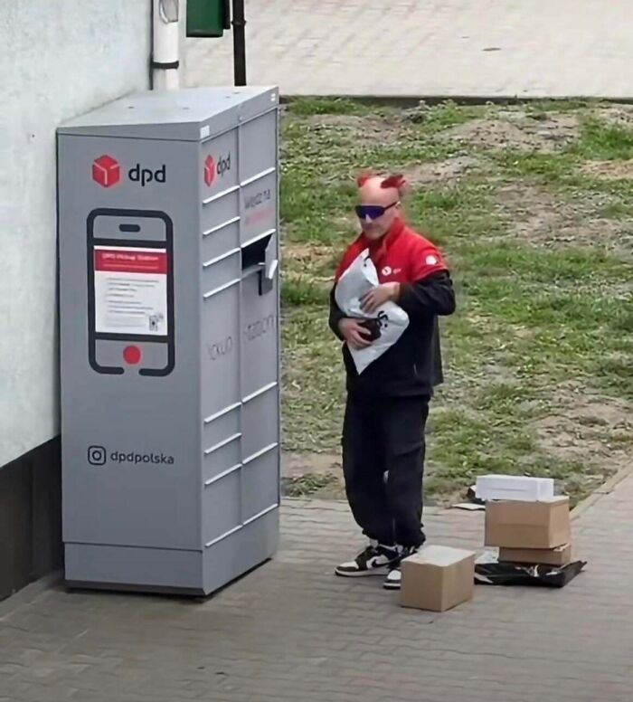 Man with a hilariously bad hair mistake, sporting small red devil horns attached to his head, holding a package.