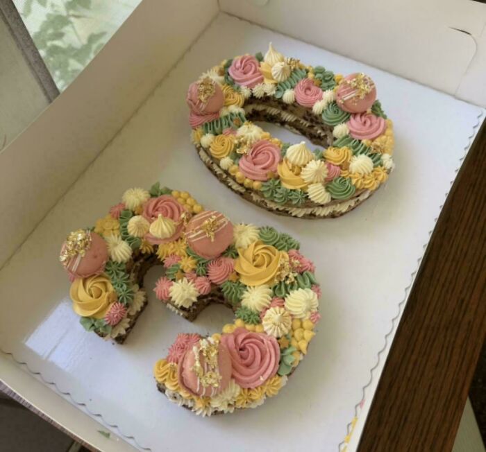 Two intricately decorated number-shaped cakes with floral frosting, a baker's amazing and delicious showpiece.