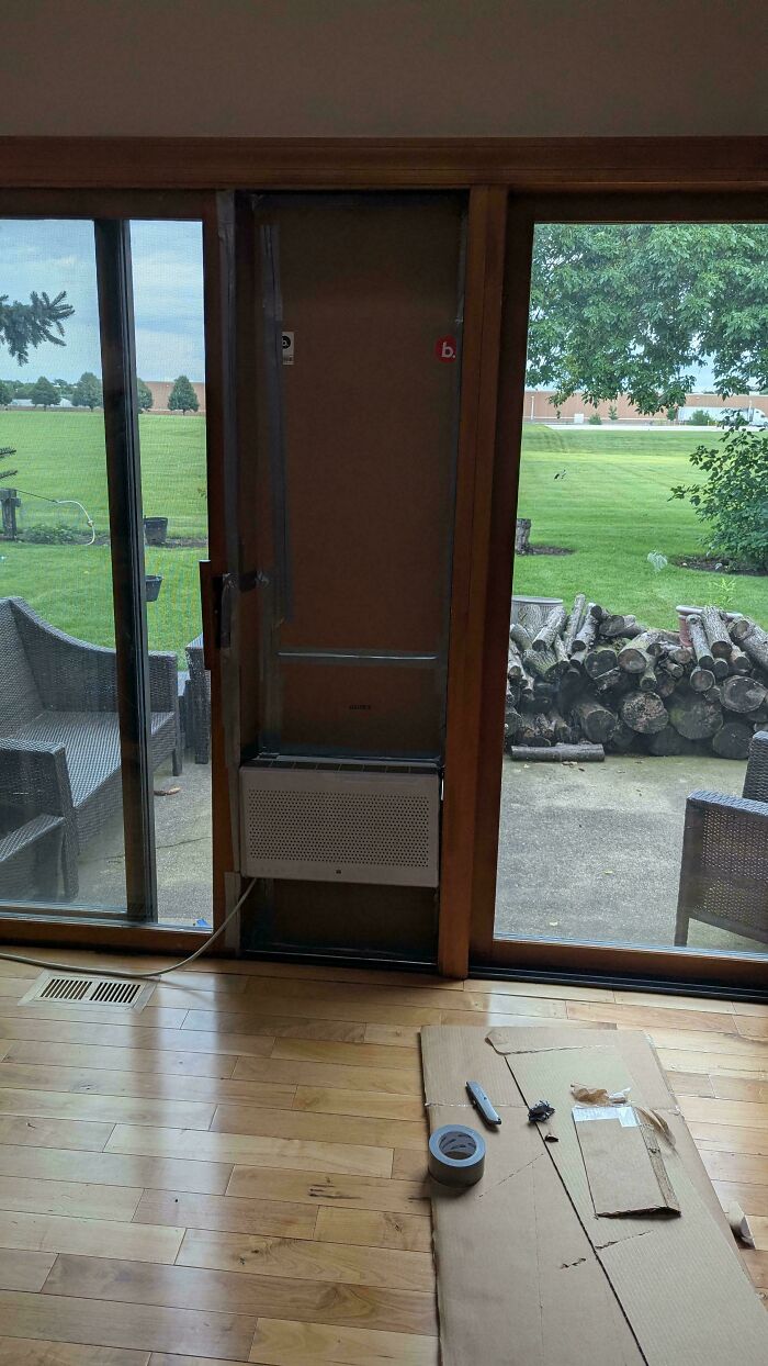 A window air conditioning unit installed in a sliding glass door opening, a clever solution.