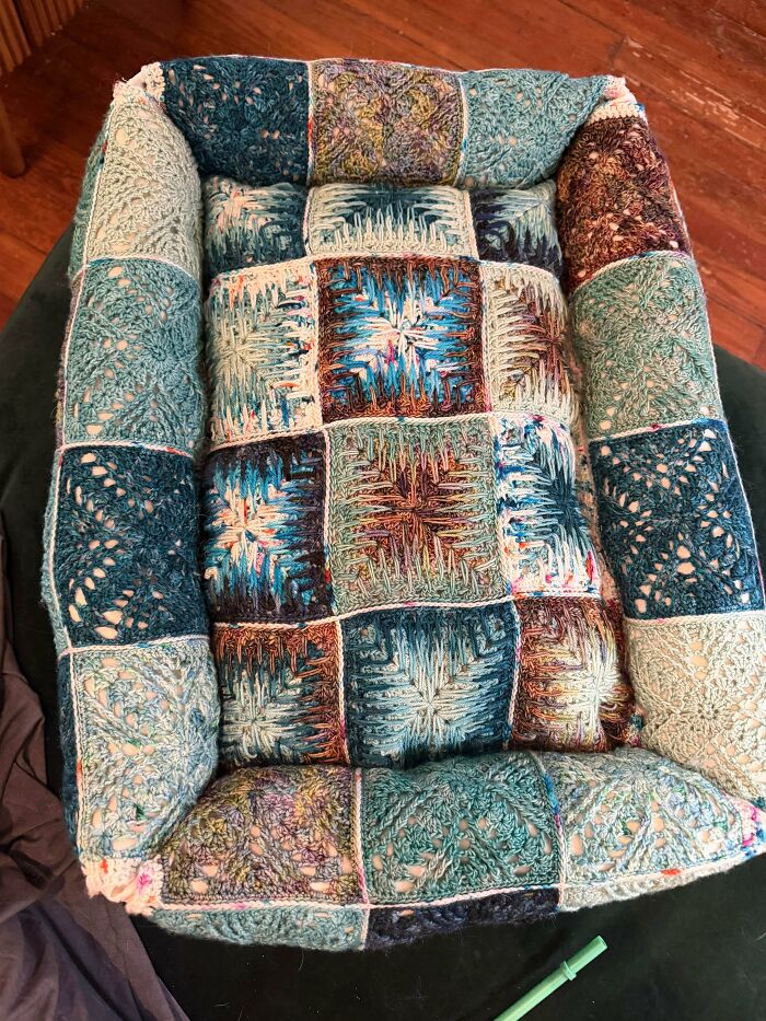 Creative crochet patchwork pet bed made with colorful yarn squares
