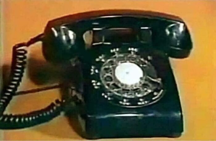 An old black rotary telephone, a clear image that takes you way back to when you could slam down the phone.
