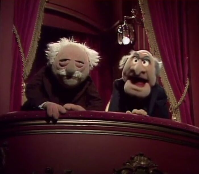 Statler and Waldorf, two Muppets, watching from a balcony, taking you way back and reminding you how old you are.