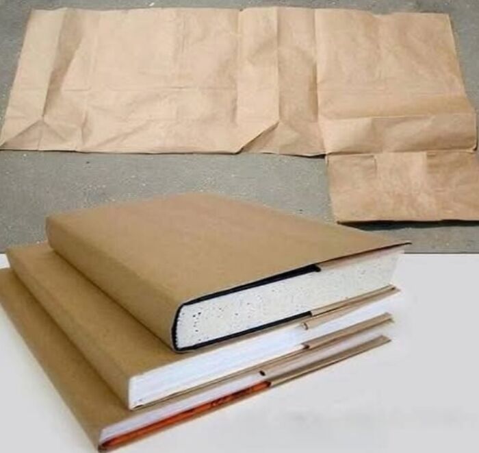 Stack of textbooks covered in brown paper bag, a classic school memory that reminds you how old you are.