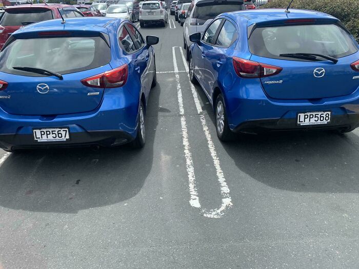 Two identical blue Mazda cars parked side-by-side, showcasing incredibly satisfying paint matches.