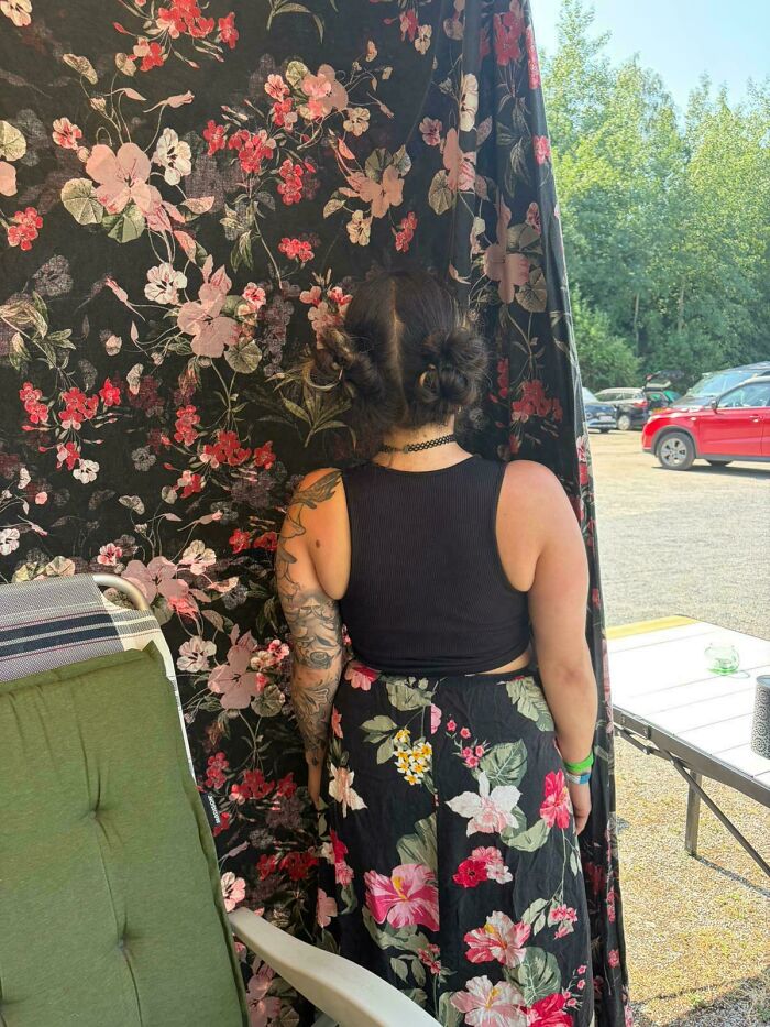 A woman from behind, her floral skirt perfectly matching the pattern of a decorative screen. Satisfying paint matches.