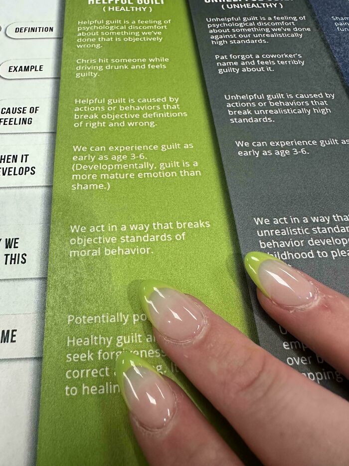 Fingernails with neon green tips match the green background of a helpful guilt explanation, a satisfying paint match.