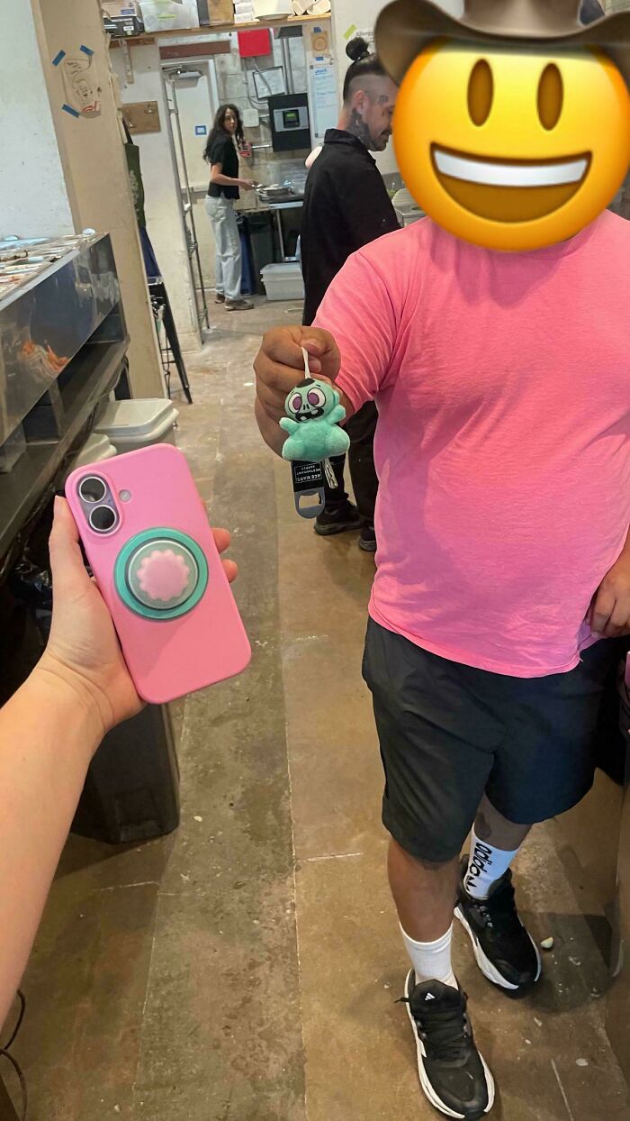A pink iPhone case with a teal pop socket matches a person's shirt and a keychain, demonstrating satisfying paint matches.