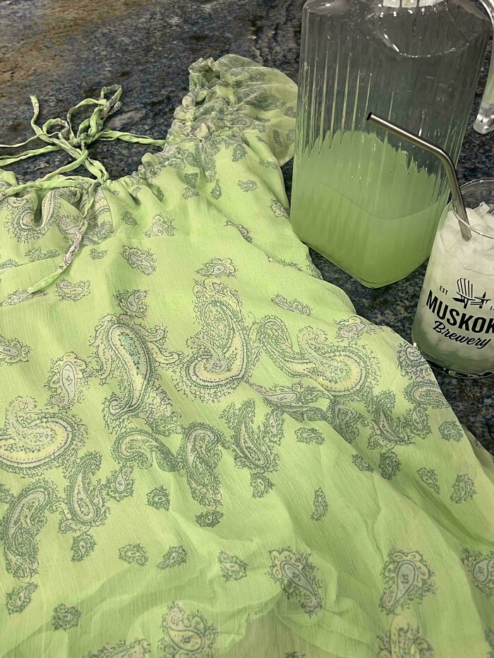A light green patterned top next to a pitcher and glass of matching green liquid, highlighting satisfying paint matches.