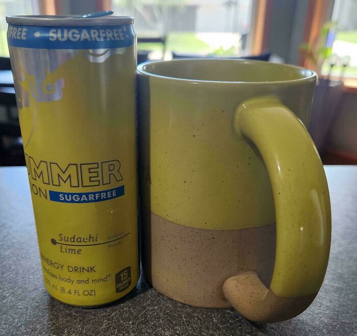 A sugar-free energy drink can perfectly matching a two-toned mug, showcasing satisfying paint matches.
