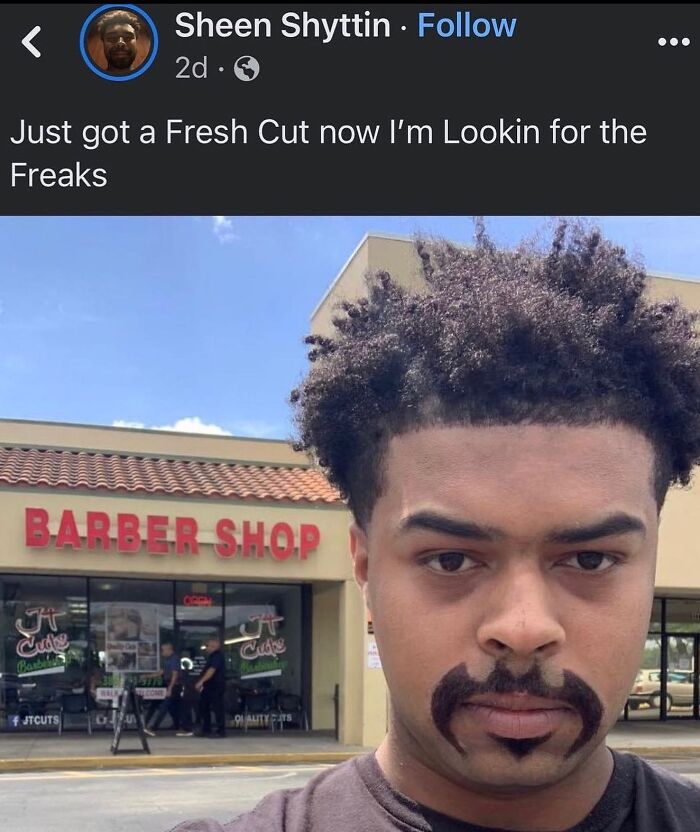 A man with a unique beard design and a fresh haircut stands in front of a barber shop, perfect for weird memes.