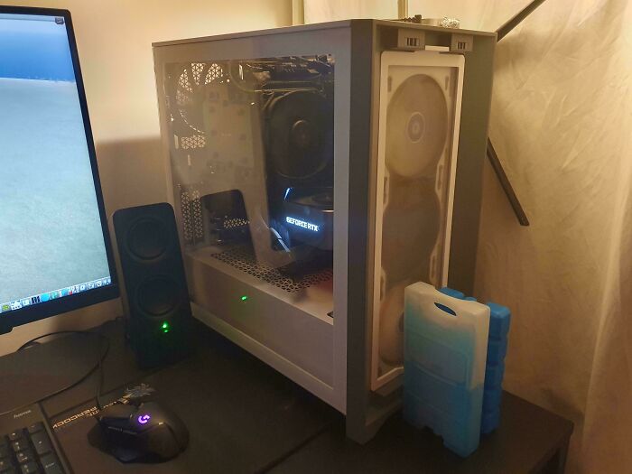 Ice packs placed next to a computer tower, a clever solution for keeping electronics cool.