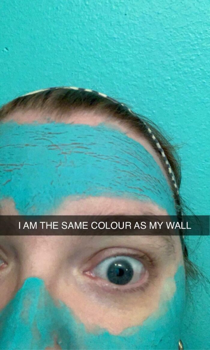 A person with a blue face mask perfectly matching the turquoise paint on the wall behind them, showcasing a satisfying paint match.