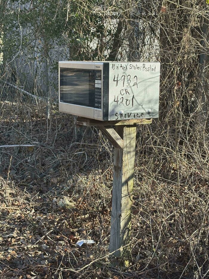 A microwave oven converted into a mailbox, illustrating the price difference and consumerism.