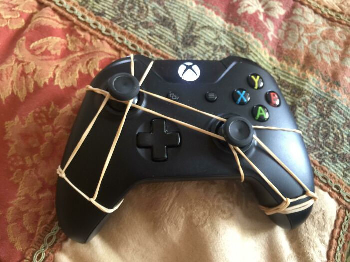 An unhinged way to fix an Xbox controller with multiple rubber bands holding down joysticks.