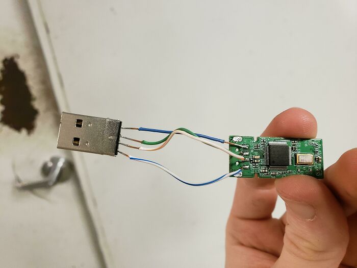 Wild and unhinged way to fix a USB drive with exposed wires connecting a USB plug to a circuit board.
