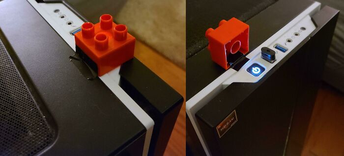 A wild way to fix a computer case power button using a red Lego brick.