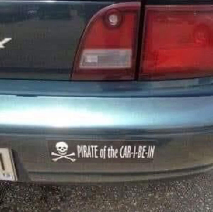A car bumper with a sticker that reads Pirate of the CAR-I-BE-IN, a classic dumb pun.