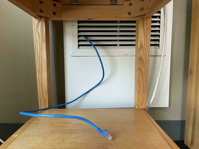 Wild and unhinged way to fix a network connection by running a cable through a vent.