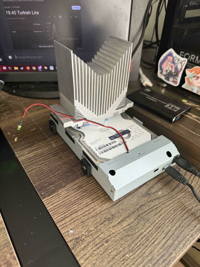 Wild and unhinged way to fix a hard drive with a large CPU cooler on top.