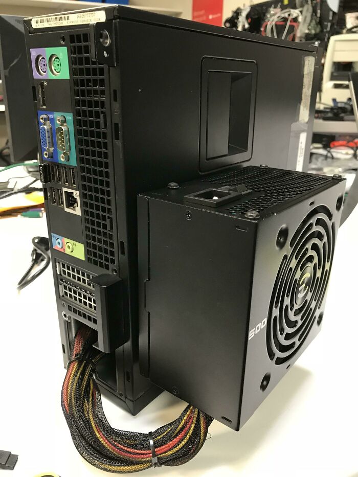 A wild and unhinged way to fix a computer, showing an external power supply attached to a PC tower.