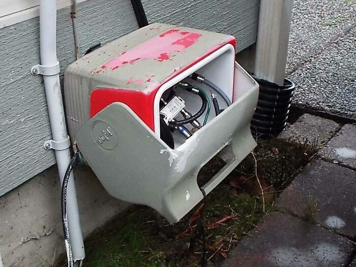 An open utility box with wires exposed, a wild and unhinged way to fix something.