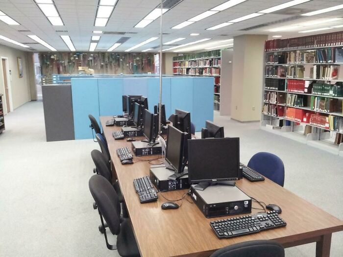Library computers with many ways to fix something, and bookshelves filled with books.