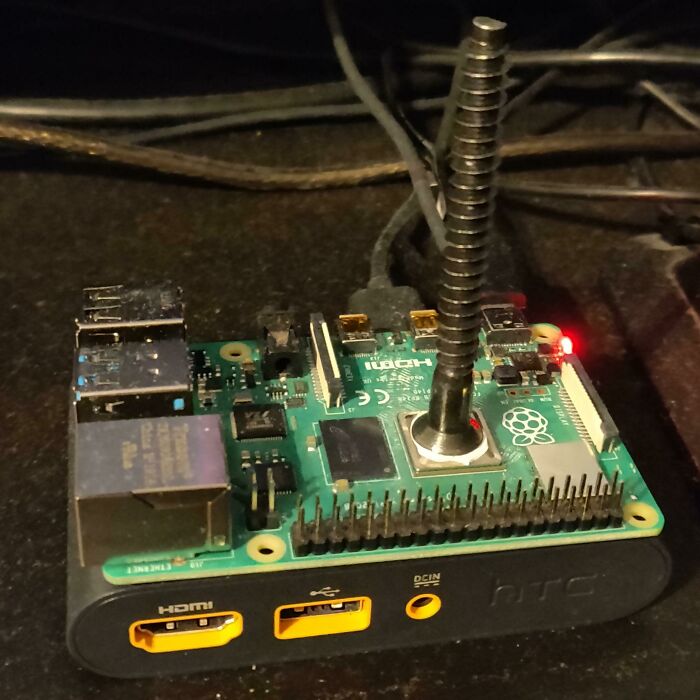 A Raspberry Pi with an unusual, tall spiral heatsink, showcasing wild and unhinged ways to fix something.