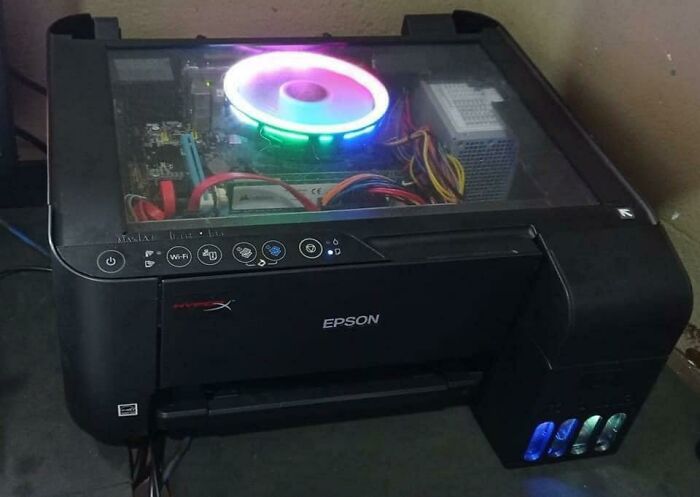 Wild and unhinged fix: a computer tower built into an Epson printer with a glowing fan.
