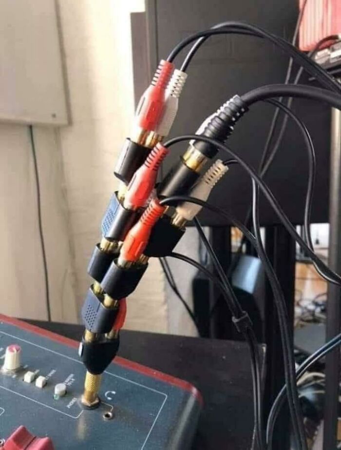 A tangle of red, white, and black audio cables, showing an unhinged way to fix connectivity.