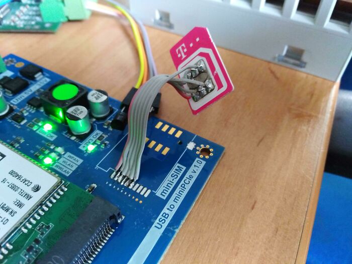 Wild and unhinged way to fix a mini-SIM card connected to a circuit board with wires and solder.