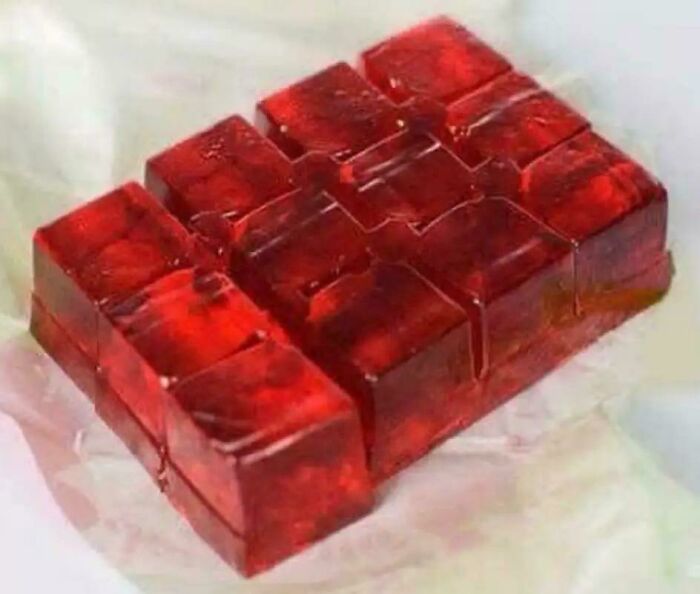 Bright red cubed jelly on a white surface, a classic treat bringing good memories of life in the 80s.