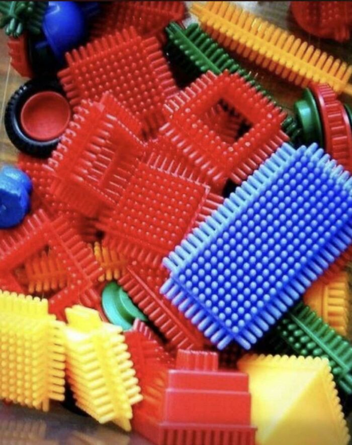 A colorful pile of plastic building blocks with textured bristles, sparking good memories of play and life in the 80s.