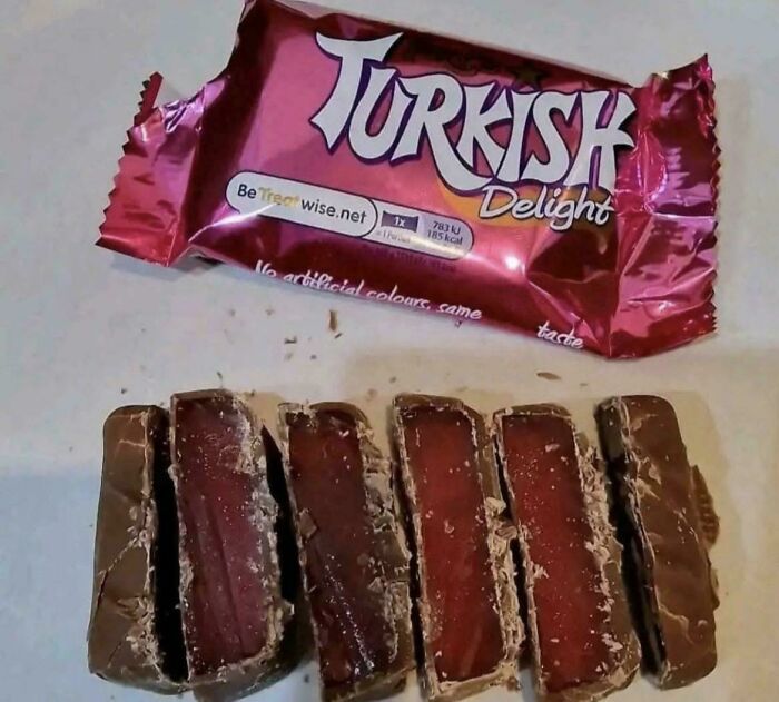 An unwrapped Turkish Delight chocolate bar with its dark pink jelly filling exposed, a sweet memory of life in the 80s.