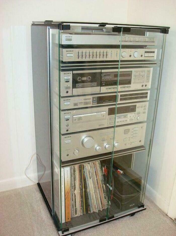 A retro Sony stereo system in a glass cabinet with records, a staple of good memories of life in the 80s.