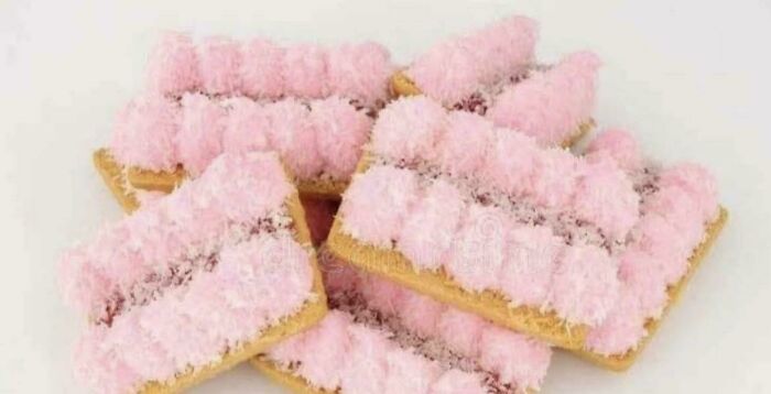A pile of pink iced biscuits, a sweet treat that brings back good memories of life in the 80s.