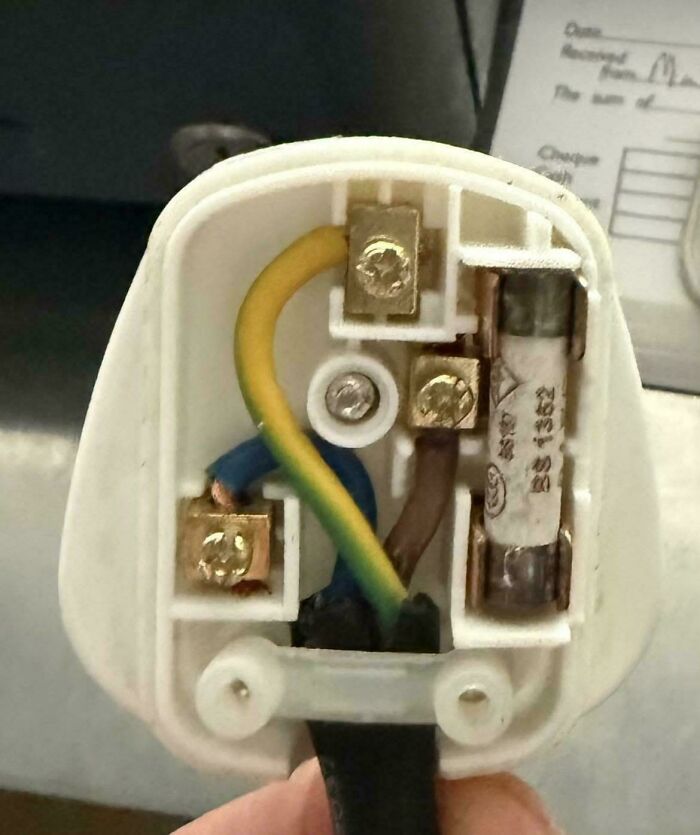 The inside wiring of an old electrical plug, reminding us of good memories of life in the 80s.