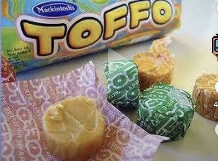 A close-up of Mackintosh's Toffo candies, unwrapped and in their wrappers, evoking good memories of life in the 80s.