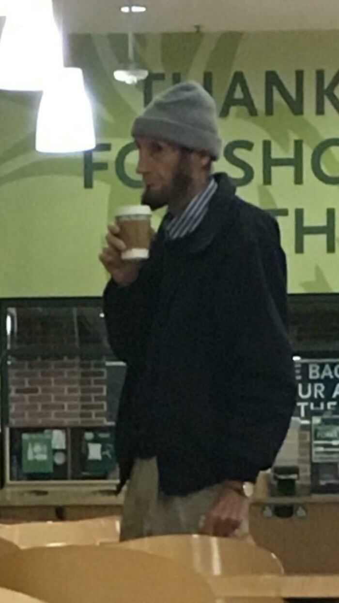 A man resembling Abraham Lincoln with a modern beanie and coffee, a photo that may need a second look.