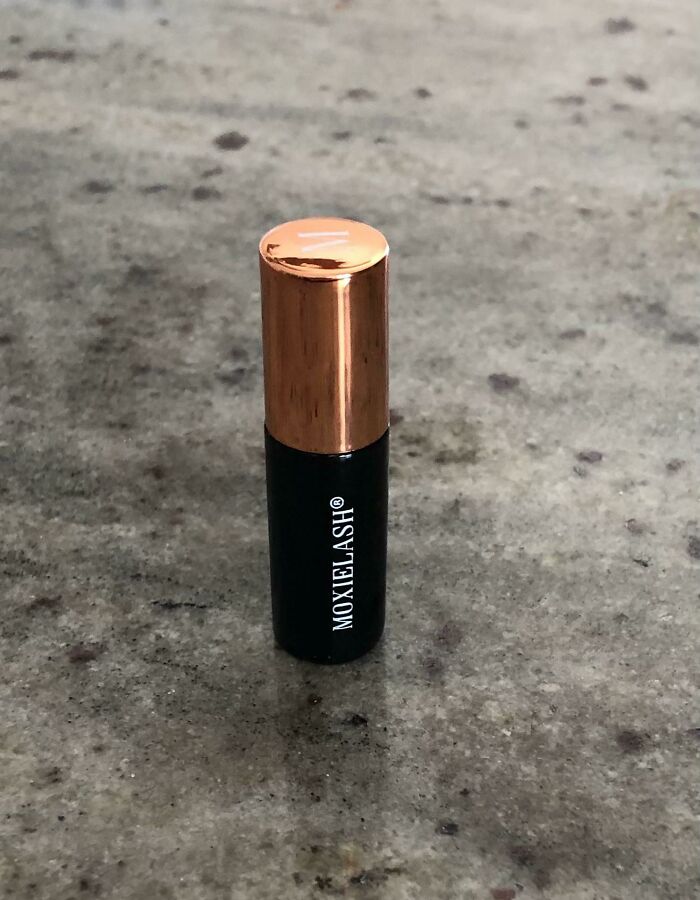A small black tube with a copper cap, labeled MOXIELASH®, an item that you may need to look twice at.