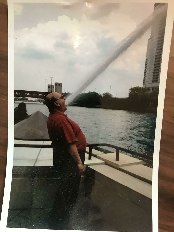 A man appears to be drinking from a large water jet in a photo that you may need to look twice at.