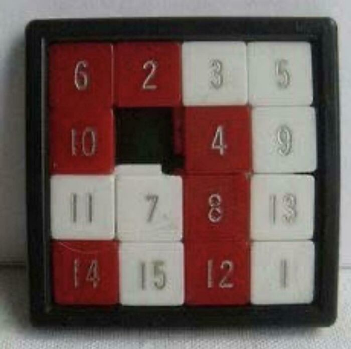 A classic sliding number puzzle with red and white tiles, a popular toy from life in the '80s.