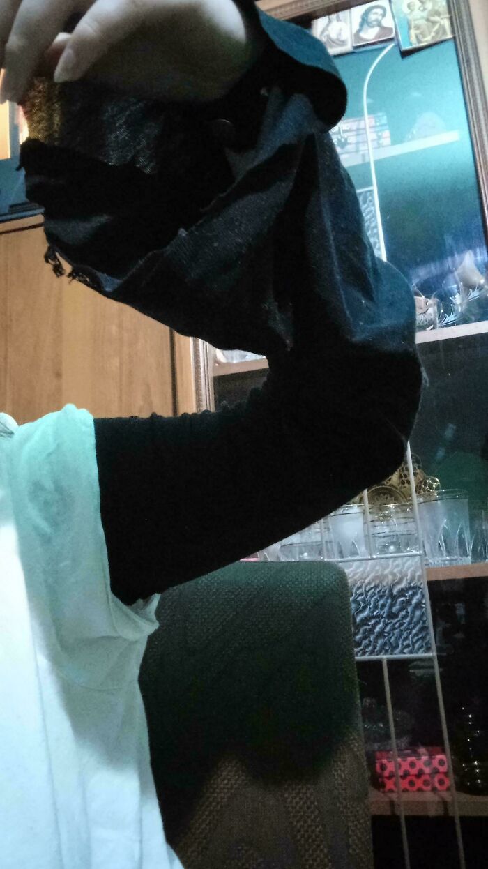 A hand wearing a black sleeve. Creativity turned old junk into something worth keeping.